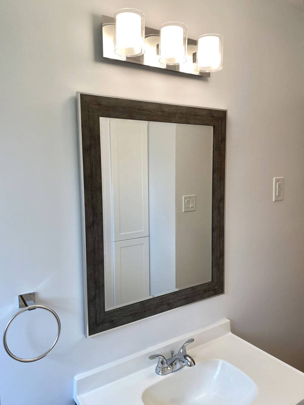 The new light fixture was moved to align with the mirror and vanity.