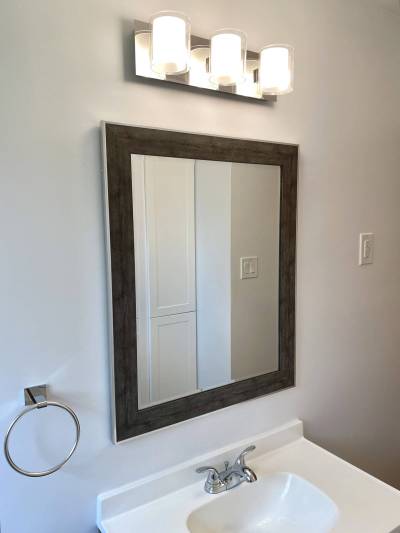 The new light fixture was moved to align with the mirror and vanity.