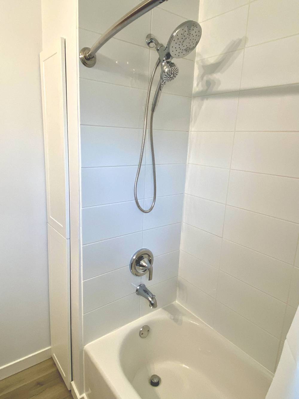 The new tub spout, shower head and faucet complement the updated stall.