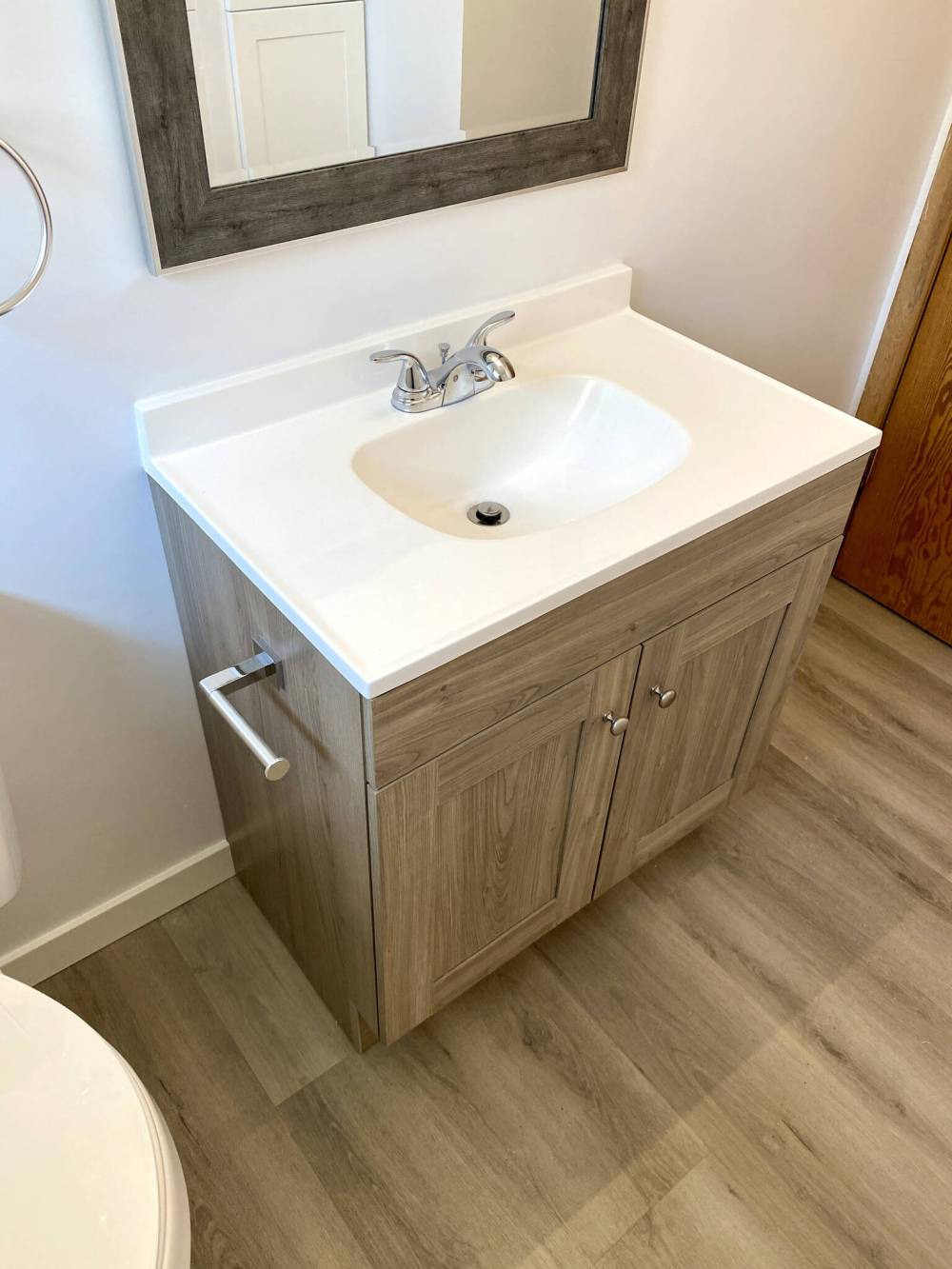 The new vanity is centred below the matching mirror.