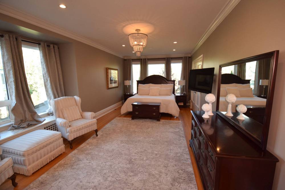 Todd Lewys / Free Press
The primary bedroom is a warm, inviting retreat filled with natural light and featuring a deluxe walk-in closet with custom slat wall storage.