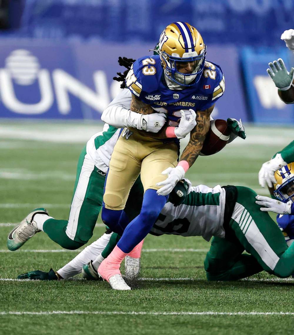 John Woods / THE CANADIAN PRESS
Blue Bombers’ Trey Vaval fumbles the ball as he is tackled on the opening kick return by the Roughriders’ Kerfalla Exumé.
