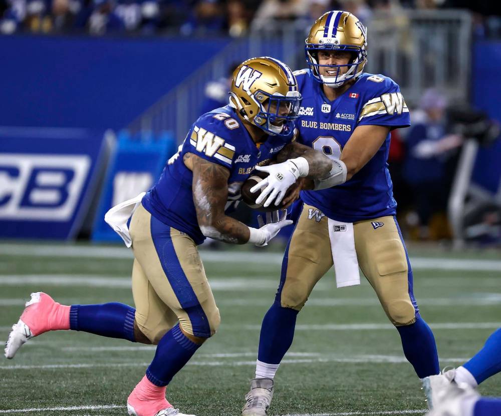 John Woods / THE CANADIAN PRESS
Bombers quarterback Zach Collaros hands off to Brady Oliveira against the Roughriders, Friday.