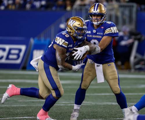 John Woods / THE CANADIAN PRESS
                                Winnipeg QB Zach Collaros (right) hands off to Brady Oliveira during the Bombers victory over the Saskatchewan Roughriders on Friday.