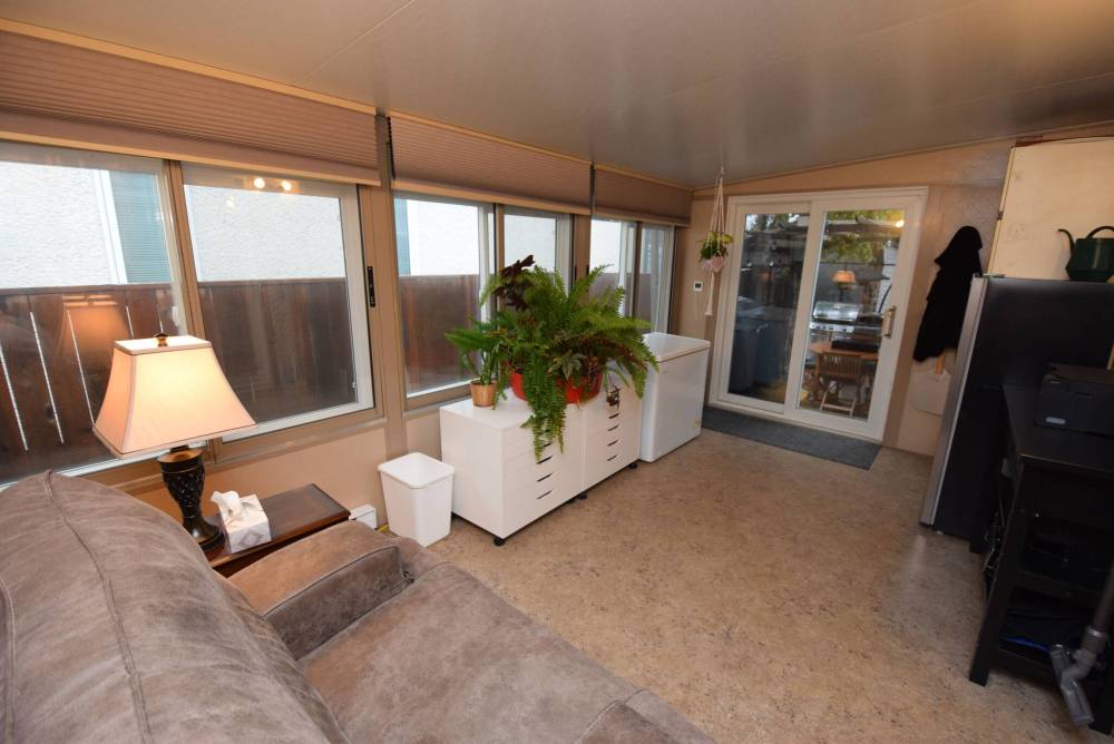 TODD LEWYS / FREE PRESS
The insulated sunroom has a wall of windows and patio door leading to the backyard.