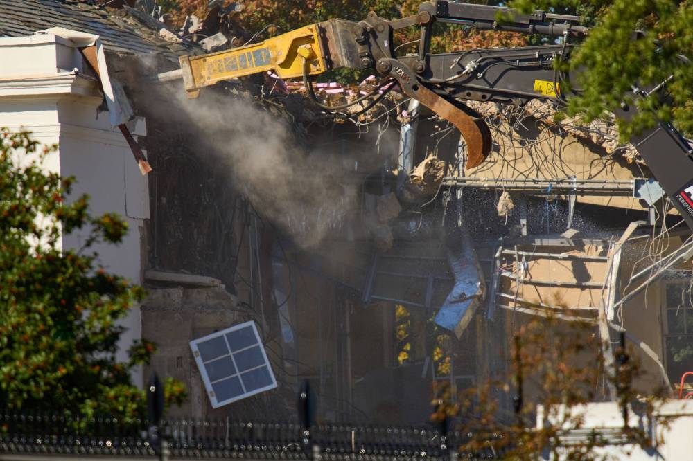 The Associated Press
                                A window dangles as work continues Tuesday on the demolition of a part of the East Wing of the White House before construction of a new ballroom.
