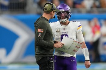 Minnesota Vikings head coach Kevin O'Connell and quarterback J.J. McCarthy (9) talk during the second half of an NFL football game against the Detroit Lions Sunday, Nov. 2, 2025, in Detroit. (AP Photo/Paul Sancya)