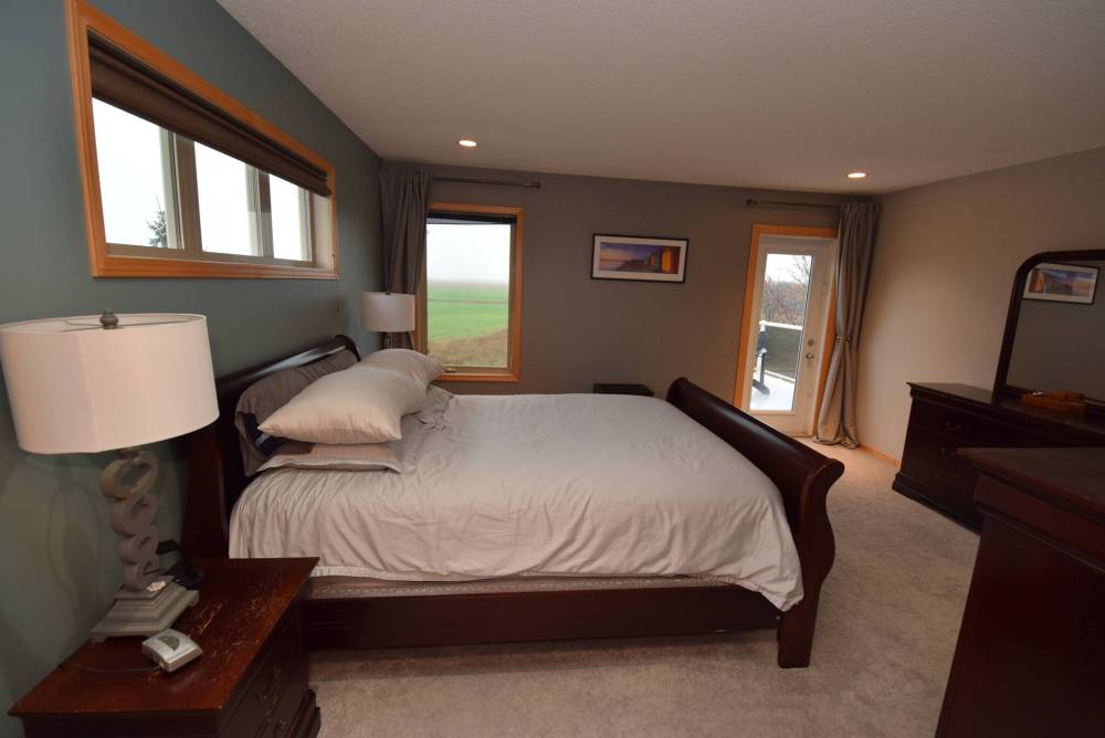 Todd Lewys / Free Press
Serenity pervades the privately positioned primary bedroom, which features access via a patio door to an elevated balcony overlooking the yard and neighbouring grasslands.