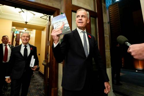 JUSTIN TANG / THE CANADIAN PRESS FILES
                                Prime Minister Mark Carney holds up a copy of the budget on Nov. 4.