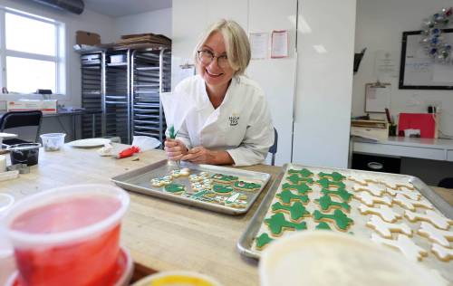 High Tea Bakery owner Belinda Bigold decorates Remembrance Day cookies. A portion of the sales will be given to the Deer Lodge Centre Foundation.