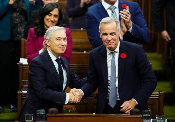 Finance Minister Francois-Philippe Champagne shakes hands with Prime Minister Mark Carney after delivering his budget speech in the House of Commons, in Ottawa, on Tuesday. (The Canadian Press)