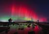 Owen Humphreys/ The Associated Press
                                The aurora borealis glow in the sky over St Mary&rsquo;s Lighthouse in Whitley Bay on the North East coast, England.