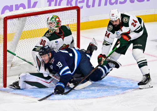 Minnesota Wild Zach Bogosian (24) dumps Winnipeg Jets&rsquo; Jonathan Toews (19) in front of his goaltender Jesper Wallstedt (30) during first period of Sunday&rsquo;s game. (Fred Greenslade / The Canadian Press)
