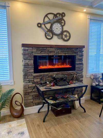Photos by Marc LaBossiere / Free Press
                                The cultured stone encapsulates the new wall-mount fireplace, creating a prominent eye-catcher in the dining room.