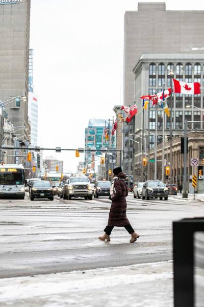 MIKAELA MACKENZIE / FREE PRESS files
                                A pedestrian crosses at Portage and Main.