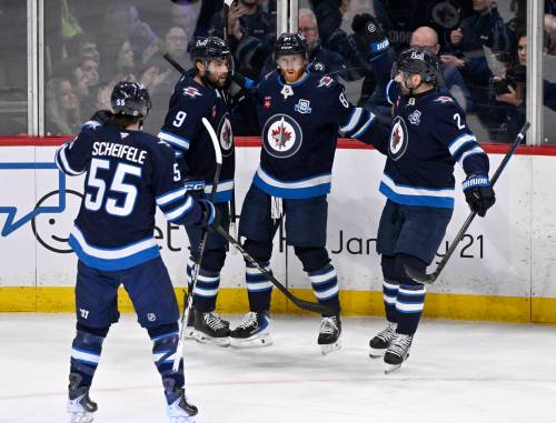 Fred Greenslade / THE CANADIAN PRESS
                                Winnipeg Jets&rsquo; Kyle Connor celebrates his goal against the New York Islanders with Alex Iafallo (9), Dylan DeMelo (2) and Mark Scheifele (55) in the first period.