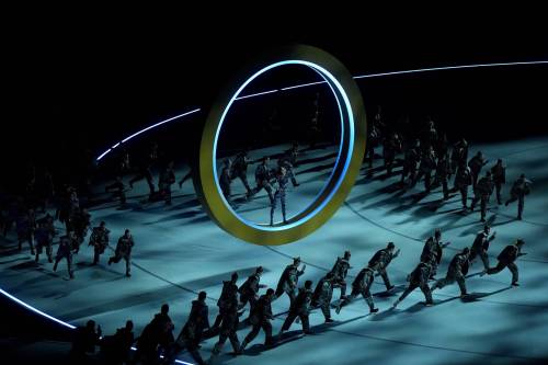 Darryl Dyck / the Canadian Press
                                Volunteers perform during the opening ceremony at the Milano Cortina Winter Olympics Friday in Milan.