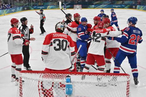 JULIEN DE ROSA / THE ASSOCIATED PRESS
                                Players scuffle during a preliminary round match of men&rsquo;s hockey between the United States and Denmark at the 2026 Winter Olympics, in Milan, Italy on Saturday.