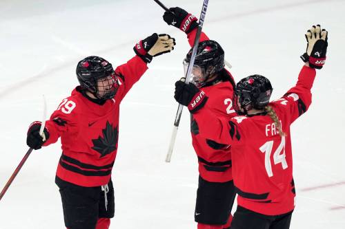 Canada&rsquo;s Marie-Philip Poulin (29) celebrates with Sophie Jaques (2) and Renata Fast (14) after Poulin scored a goal against Switzerland during the second period of a women&rsquo;s ice hockey semifinal match at the 2026 Winter Olympics, in Milan, Italy, Monday, Feb. 16, 2026. (Carolyn Kaster / The Associated Press)