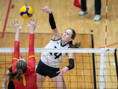 BROOK JONES/FREE PRESS
                                Wesmen outside hitter Ella Werbiski (No. 14) spikes the ball while Dinos middle/outside hitter Leni Blanke (No. 1) goes up for the block.
