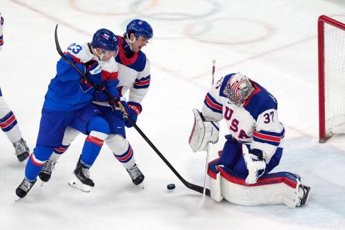 CAROLYN KASTER / THE ASSOCIATED PRESS
                                Slovakia&rsquo;s Adam Liska (23) battles with United States&rsquo; Brock Faber (centre) for the puck in front of U.S. goalie Connor Hellebuyck (37) during the third-period of the semifinal game at the 2026 Winter Olympics in Milan, Italy.