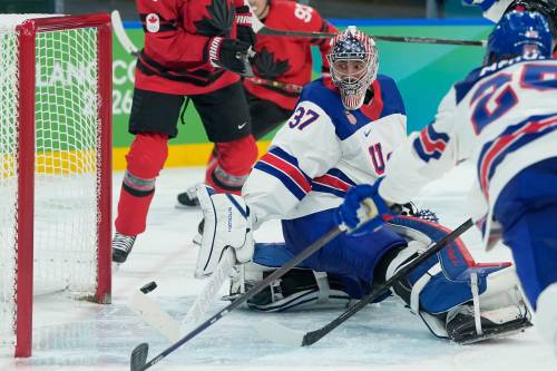 United States&rsquo; Connor Hellebuyck (37) makes a stick save against Canada during the third period of Sunday&rsquo;s game. (Petr David Josek / The Associated Press)