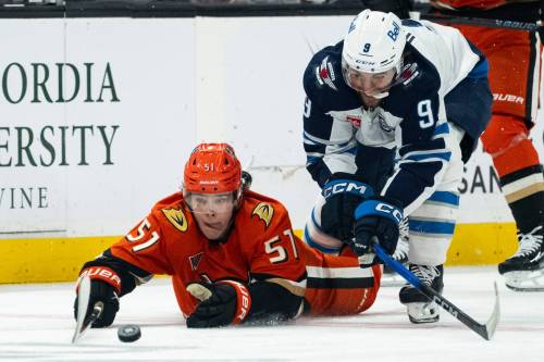 Kyusung Gong / The Associated Press
                                Anaheim Ducks defenceman Olen Zellweger, left, and Winnipeg Jets left wing Alex Iafallo battle for the puck during the second period.