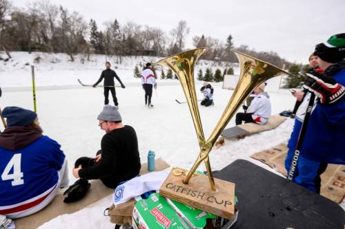 MIKE SUDOMA / FREE PRESS
                                Musicians and friends take part in the 5th annual Catfish Cup hockey tournament on the Assiniboine River in the Wolseley neighbourhood on Sunday afternoon. The hockey tournament featuring members of the local band Dirty Catfish Brass Band, along with their friends and fellow musicians, is an annual community event held at one of the man-made rinks along the Assiniboine River.