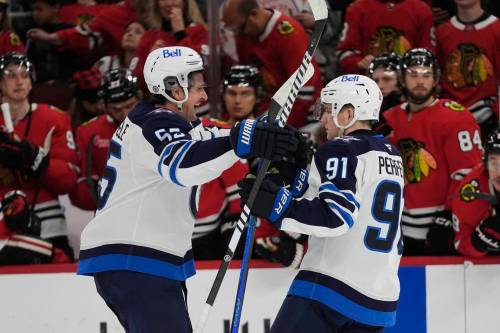 Erin Hooley / The Associated Press Files
                                Winnipeg Jets Mark Scheifele, left, and Cole Perfetti.