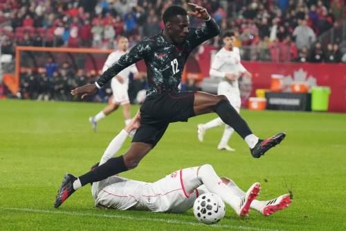 CHRIS YOUNG / THE CANADIAN PRESS
                                Canada&rsquo;s Tani Oluwaseyi leaps over Tunisia&rsquo;s Omar Rekik during the teams&rsquo; 0-0 draw on Tuesday. The way all three World Cup co-hosts &mdash; Canada, the United States and Mexico &mdash; have played recently has raised the concern that the second knockout stage may be as far as the co-hosts can reasonably advance.