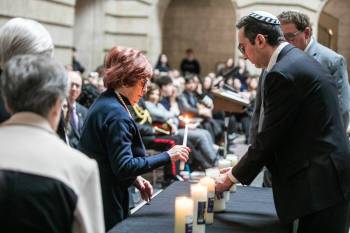 MIKAELA MACKENZIE / FREE PRESS
                                Judith Lavitt lights a candle at the Yom HaShoah annual Holocaust commemoration at the Manitoba Legislative Building, April 14.