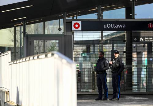 OC Transpo Special Constables stand outside a closed uOttawa Station at the University of Ottawa on April 10. (Spencer Colby / The Canadian Press files)