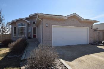 The well-kept bungalow is built on an oversized country lot backing onto wide-open space.