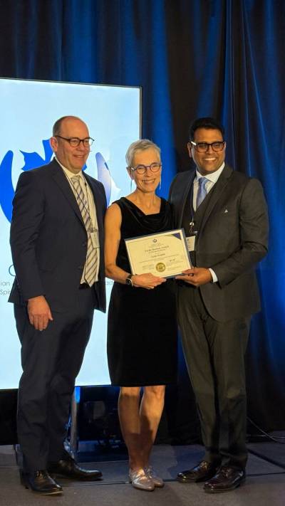 SUPPLIED
                                Lynn Granke (centre) receives her award from Jeff Chant, CEO of the Canadian Association for Spiritual Care (left), and board president Ajith Varghese.