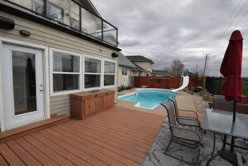 Todd Lewys photos / Free Press
                                The backyard at 50 Manring Cove, Southdale, is a private resort featuring a large deck with hot tub, outdoor shower and a low-maintenance saltwater pool.