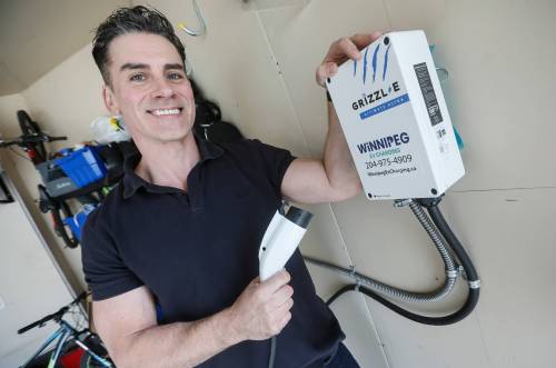 JOHN WOODS / FREE PRESS
                                Kyle Bazylo, owner of Winnipeg EV Charging, is photographed at his home where he has a charging unit and charges his electric car Tuesday, May 19, 2026. Statistics Canada numbers show that MB has achieved record sales of electric cars. reporter: Malak