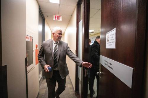 MIKAELA MACKENZIE / FREE PRESS
                                Commissioner Garth Smorang walks into the Winnipeg Police Service headquarters inquiry hearings at the Public Utility Board offices on Feb. 10.
