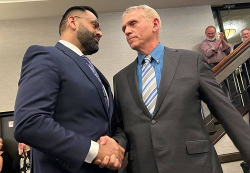 File
                                Obby Khan (left) shakes hands with Wally Daudrich after winning the leadership of the Progressive Conservative Party of Manitoba.