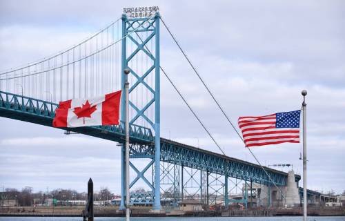 ROB GURDEBEKE / THE CANADIAN PRESS FILES
                                Canadian and American flags fly near the Ambassador Bridge at the Canada/USA border crossing in Windsor, Ont. Trump has obstructed the official opening of the bridge.