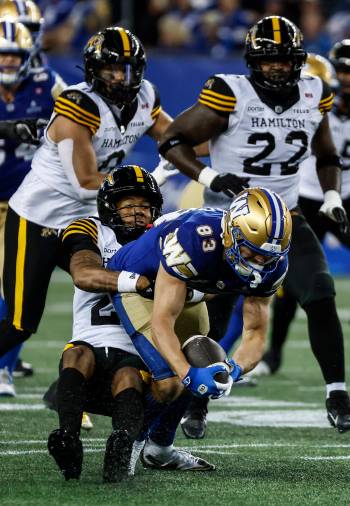 JOHN WOODS / THE CANADIAN PRESS
                                Winnipeg Blue Bombers receiver Tommy Nield fights for yards against the Hamilton Tiger-Cats defence. The receiver had his first career 100-yard game on Thursday night.