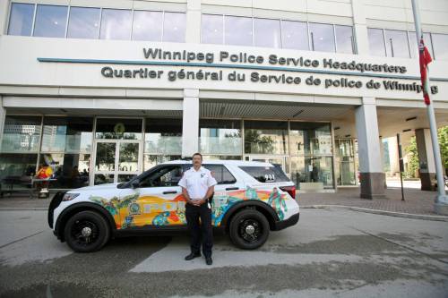 ERIK PINDERA / FREE PRESS
                                Winnipeg Police Service Chief Gene Bowers next to the cruiser covered with Indigenous art at its unveileing, Tuesday.