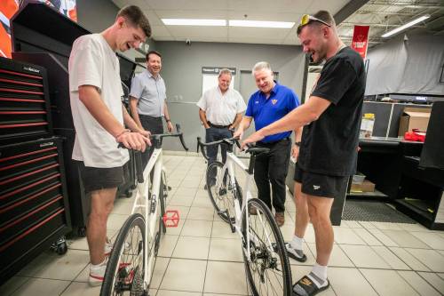 MIKAELA MACKENZIE / FREE PRESS
                                Thomas Clark (left) and Val Duquenne greet Canadian Tire folks Brad Elliott (left), Marc Gaudreau, and Chris Coenen with their new bikes on Monday.