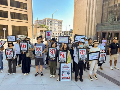 TYLER SEARLE / FREE PRESS
                                Dozens of Chinese newcomers rallied outside the Immigration, Refugees and Citizenship Canada office on Main Street Friday to protest what they describe as untenable delays to Canada&rsquo;s security screening process.