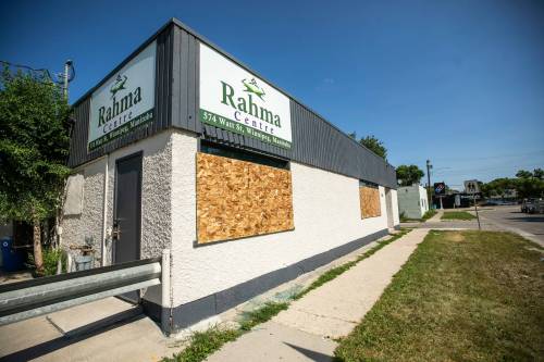 Boarded-up broken windows at the Winnipeg Rahma Islamic Centre on Friday. (Mikaela MacKenzie / Free Press)