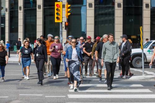 MIKE DEAL / FREE PRESS FILES
                                Pedestrians cross Portage and Main during the historic reopening of the intersection in 2025.