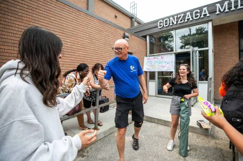MIKAELA MACKENZIE / FREE PRESS
                                Principal Rex Ferguson-Baird fist-bumps Kimber Louis, 14, at Gonzaga Middle School&rsquo;s annual summer drop-in Tuesday.