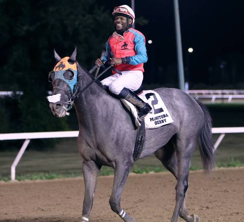 JASON HALSTEAD / ASSINIBOIA PHOTO
                                Dane Nelson celebrates after winning the Manitoba Derby on Monday aboard Western Warrior.