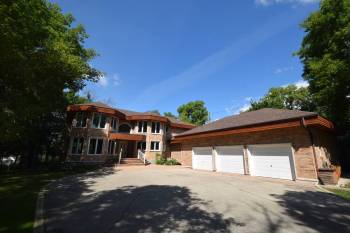 Todd Lewys / Free Press
                                Surrounded by mature trees, the 3,900 sq. ft., two-storey home offers unparalleled style and function &mdash; and a secluded, spectacular riverside setting.