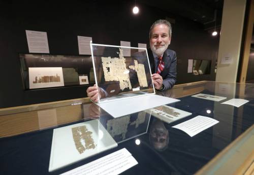 Ruth Bonneville / Free Press
                                Dr. C. Michael Sampson, Professor of Classics and a papyrologist, with a document that&rsquo;s almost 2000 years old, on view at the exhibit inside the Elizabeth Dafoe Library at the University of Manitoba, Monday.