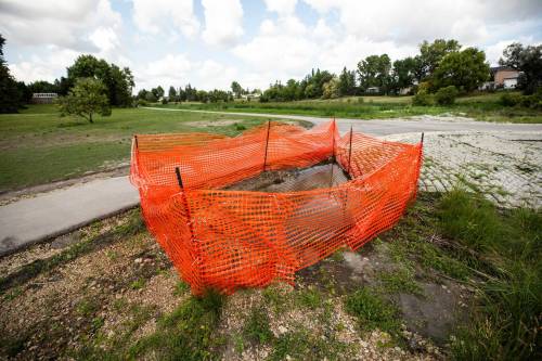 MIKAELA MACKENZIE / FREE PRESS
                                The new sinkhole was caused by intense rainstorms earlier in the summer that created a new area of erosion, city spokeswoman Julie Dooley said.